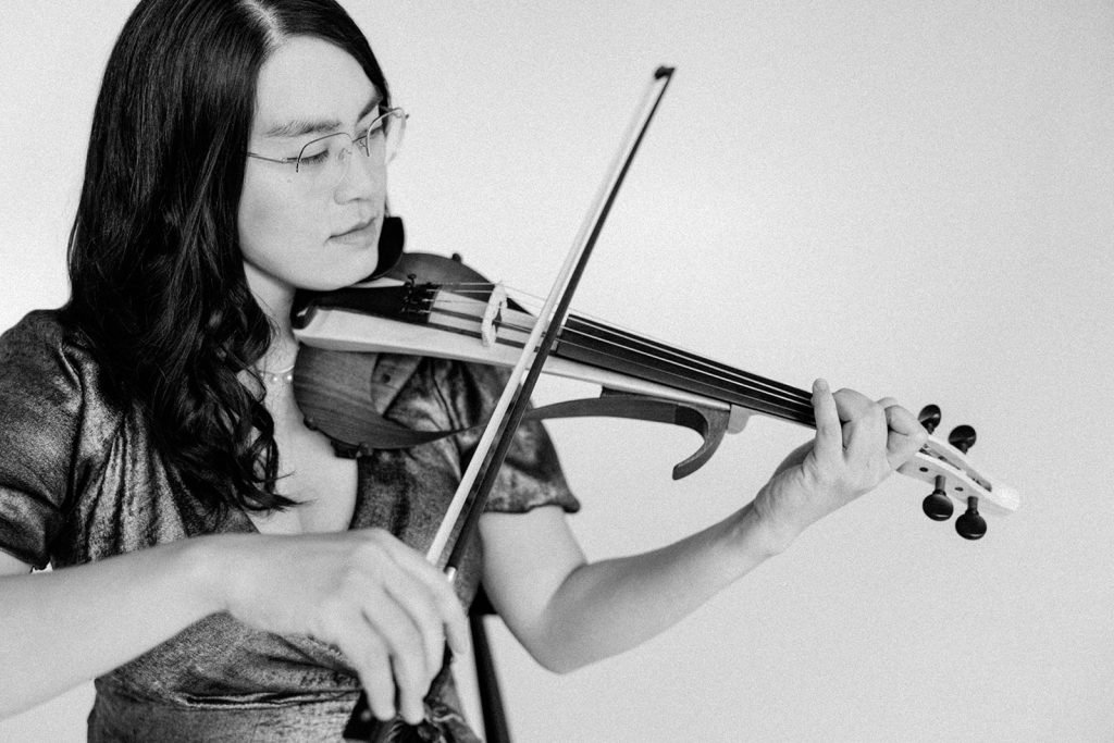 Violinist Julia Taylor Playing her electric violin 
Photo Credit @Diana Coulter